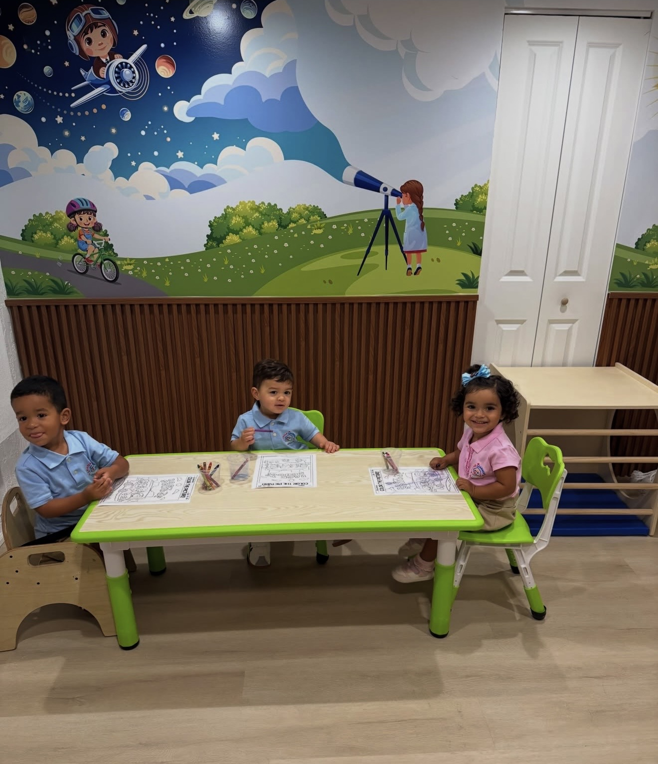 Three children at an activity table at Little Learners